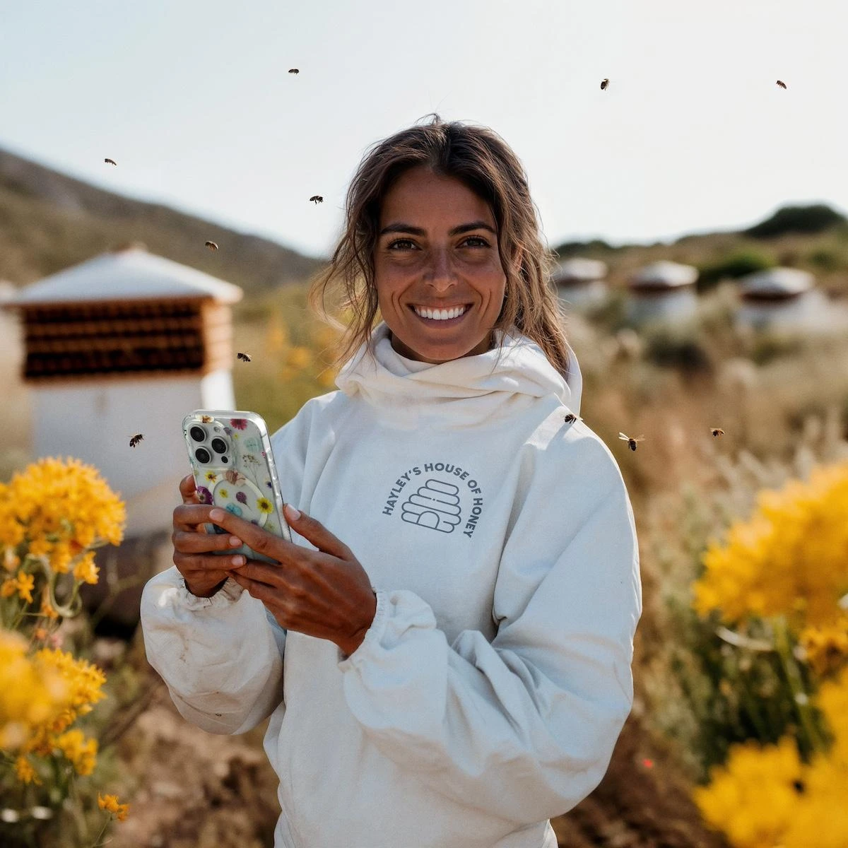 ZAGG campaign character in a beekeeping suit holding a floral phone case